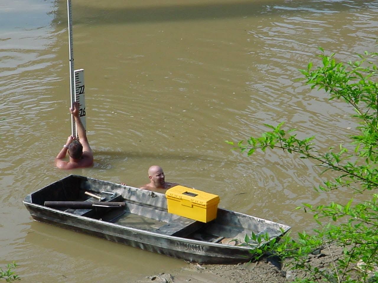 DIMCO crew installing a river staff gage from a jon boat